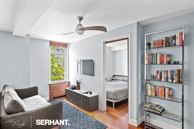 living area featuring ceiling fan and hardwood / wood-style floors