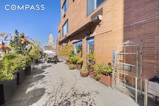 exterior space featuring outdoor dining space and a view of city