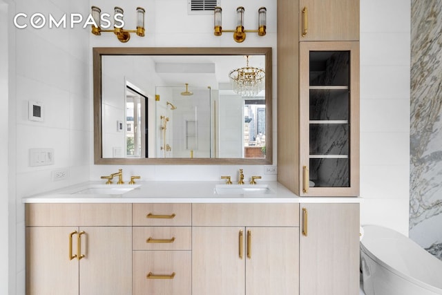 bathroom featuring vanity, toilet, an enclosed shower, and a wealth of natural light