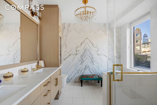 bathroom featuring double vanity, a shower stall, tile walls, and a sink