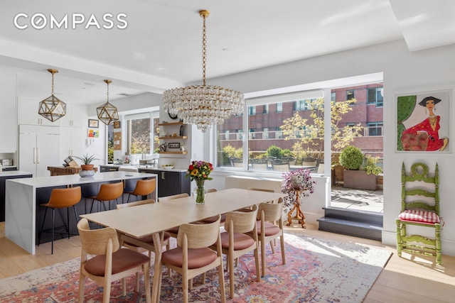 dining room with a chandelier and light wood-style floors