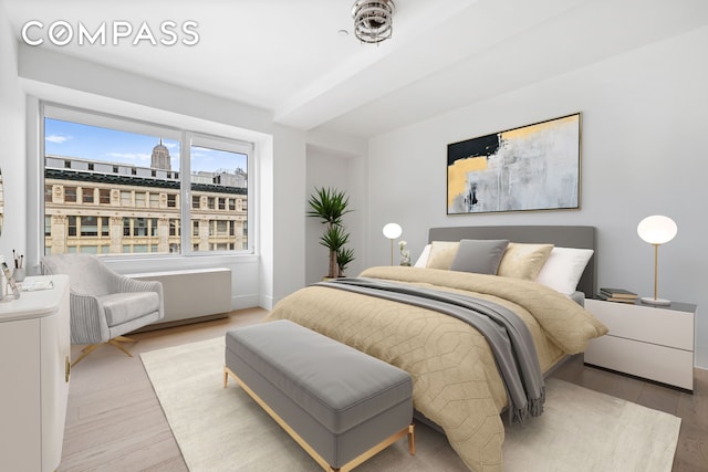 bedroom featuring baseboards and light wood-style floors