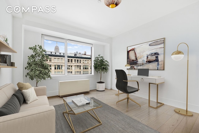 home office featuring wood finished floors and baseboards