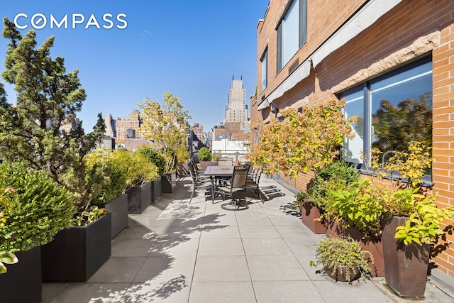 view of patio / terrace featuring a city view and outdoor dining space