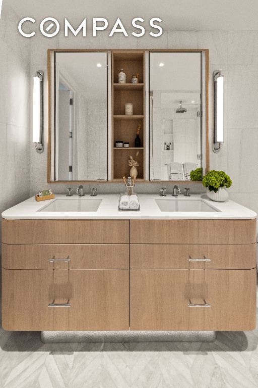 full bath with marble finish floor, a sink, and double vanity