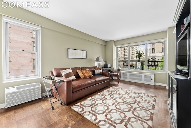 living room featuring parquet floors and a wall mounted air conditioner