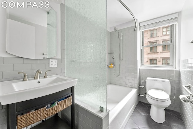 full bathroom featuring tile walls, toilet, vanity, and tile patterned flooring