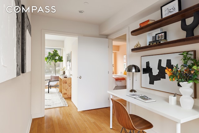 kitchen with open shelves and light wood-style floors