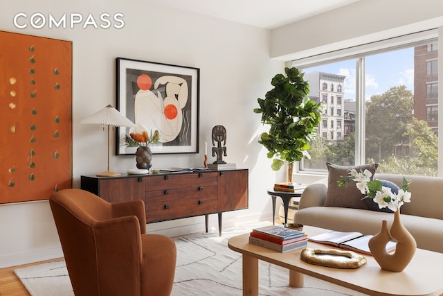 living area with light wood-style floors and baseboards