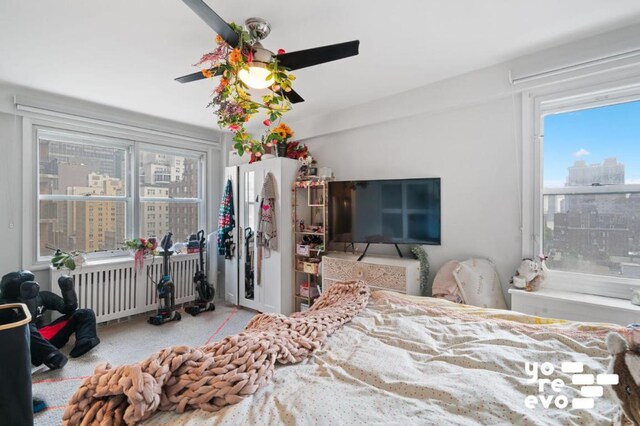 bedroom with radiator and ceiling fan