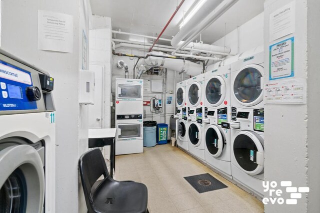 washroom with stacked washer and dryer and washing machine and clothes dryer