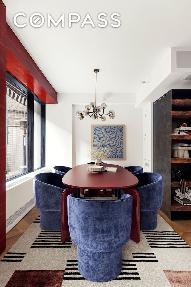 dining room featuring wood finished floors and a notable chandelier