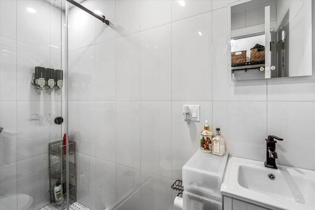 bathroom featuring walk in shower and vanity