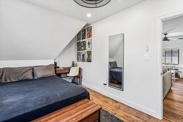 bedroom featuring hardwood / wood-style flooring and vaulted ceiling