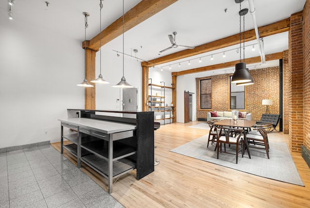 dining room with baseboards, brick wall, ceiling fan, beamed ceiling, and wood finished floors