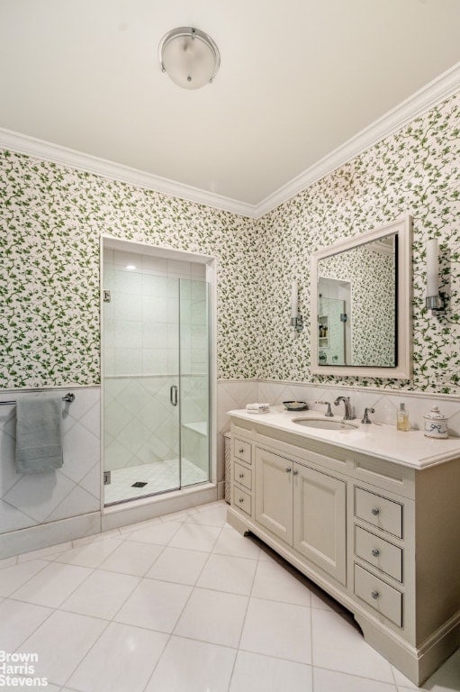 bathroom with a shower with door, crown molding, vanity, and tile patterned flooring