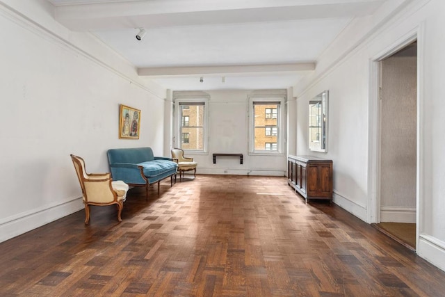 living area featuring beam ceiling and dark parquet floors