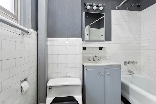 bathroom featuring tile walls, toilet, and bathing tub / shower combination