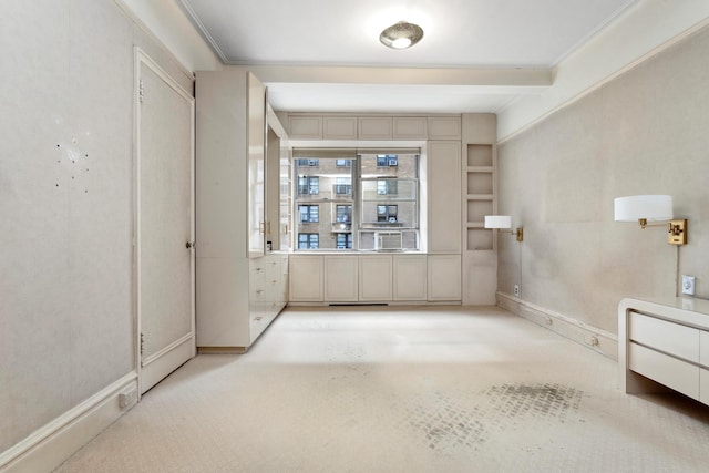 empty room featuring ornamental molding, beam ceiling, and baseboards