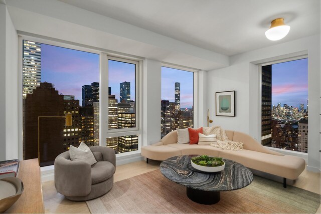 sitting room with a city view and wood finished floors