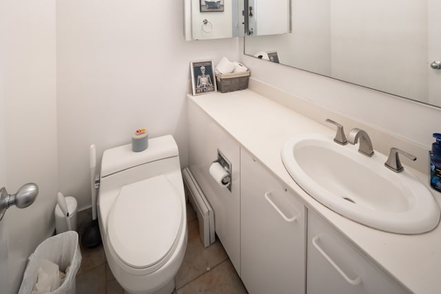 bathroom with vanity, toilet, tile patterned flooring, and a baseboard heating unit
