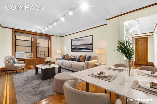 living room with hardwood / wood-style floors, cooling unit, ornamental molding, and rail lighting