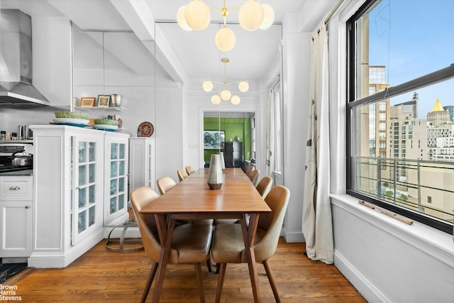 dining space featuring an inviting chandelier and light hardwood / wood-style flooring