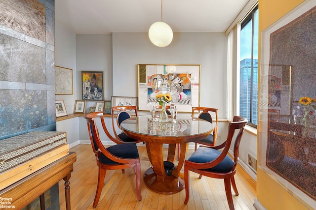 dining area featuring hardwood / wood-style floors and baseboards