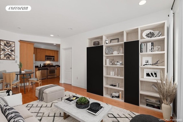 living room featuring light hardwood / wood-style floors and built in shelves