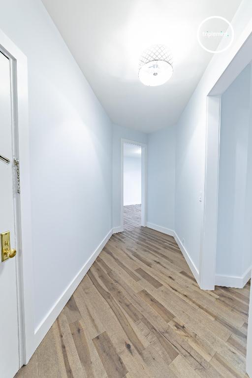 spare room with light wood finished floors and baseboards