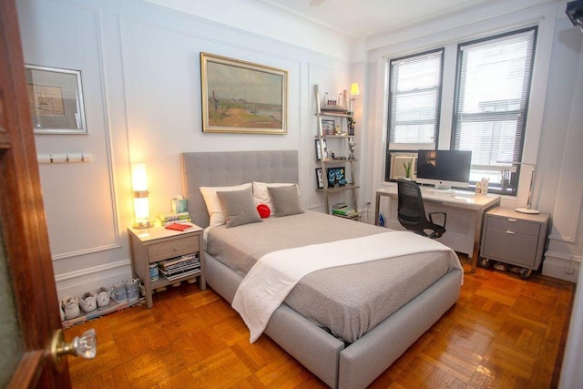 bedroom featuring parquet floors and ornamental molding