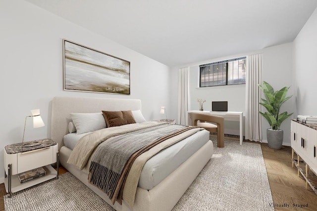 bedroom with light parquet flooring