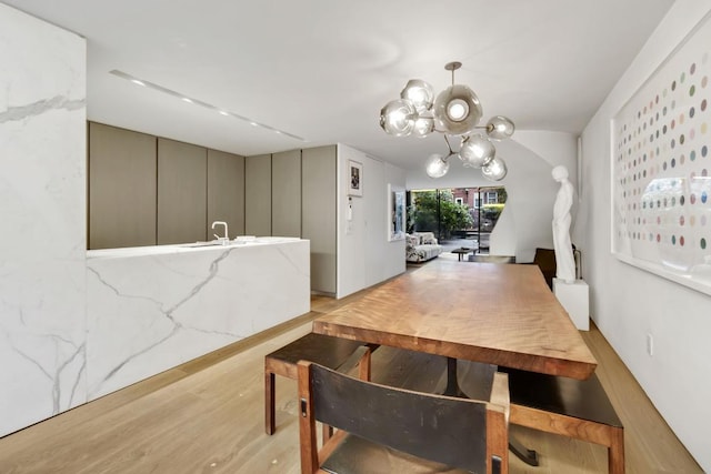 dining room featuring an inviting chandelier and light hardwood / wood-style floors