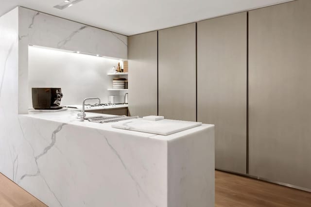 kitchen with light hardwood / wood-style floors and kitchen peninsula