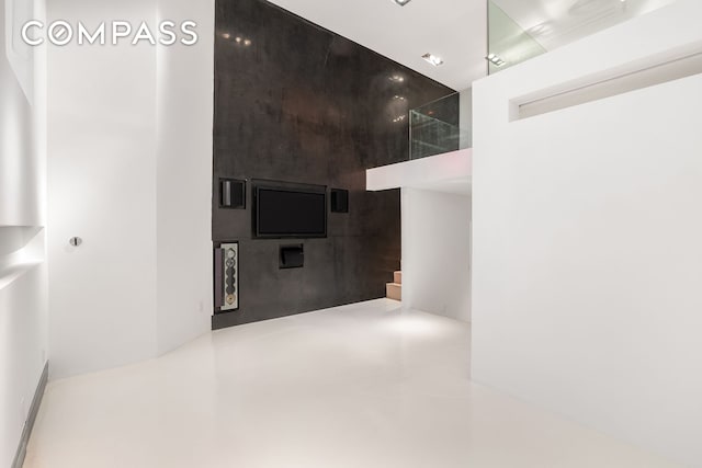 interior space featuring finished concrete flooring and stairway