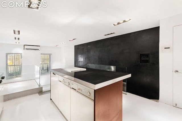 kitchen featuring white cabinetry, a kitchen island, and a wall mounted air conditioner