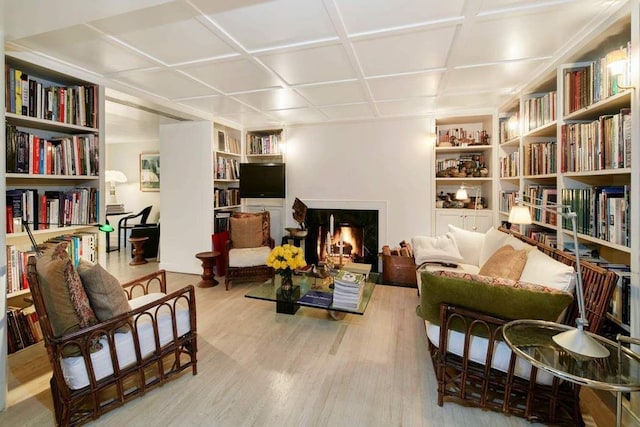 sitting room featuring light hardwood / wood-style floors and built in features