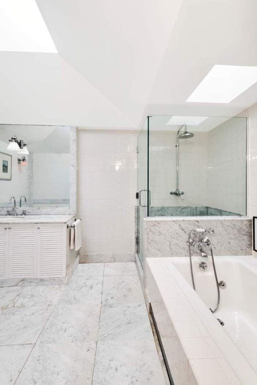 bathroom featuring vanity and shower with separate bathtub