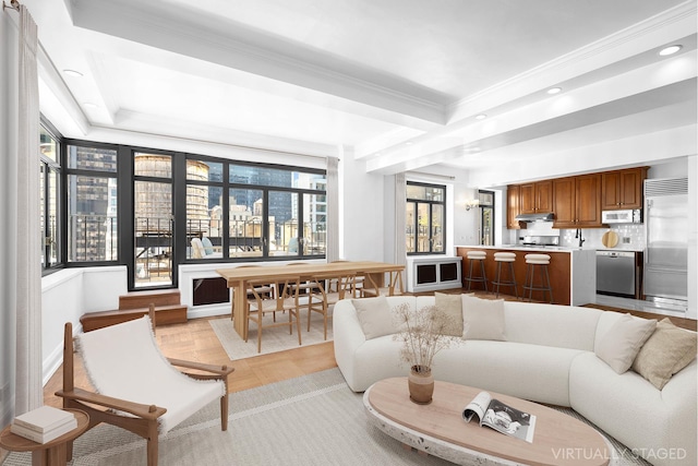 living area featuring recessed lighting, crown molding, and a tray ceiling