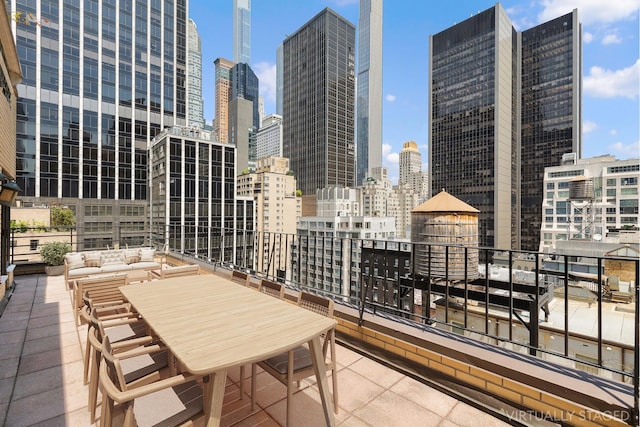 view of patio featuring a balcony and a view of city