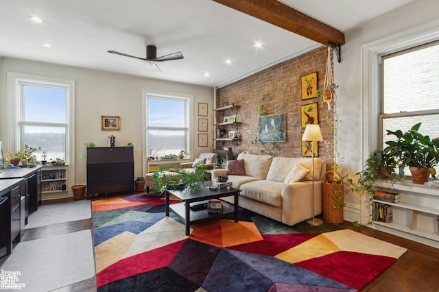 living room with beamed ceiling, recessed lighting, brick wall, and ceiling fan