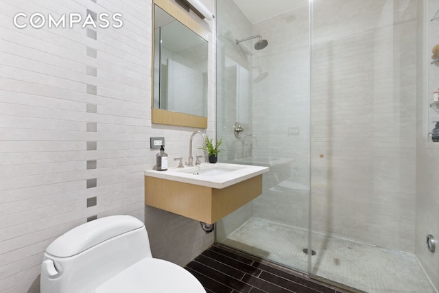 bathroom with a shower stall and toilet