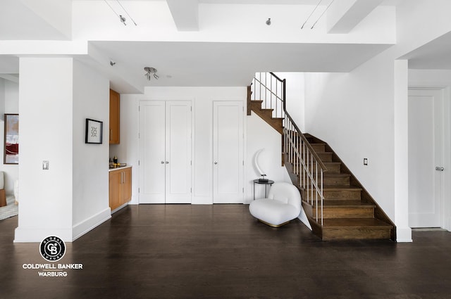 interior space with stairway, baseboards, and dark wood-style floors