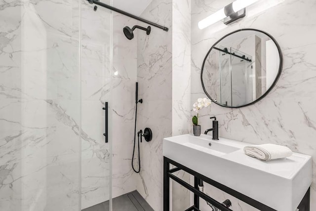 full bath with stone wall, a marble finish shower, and vanity