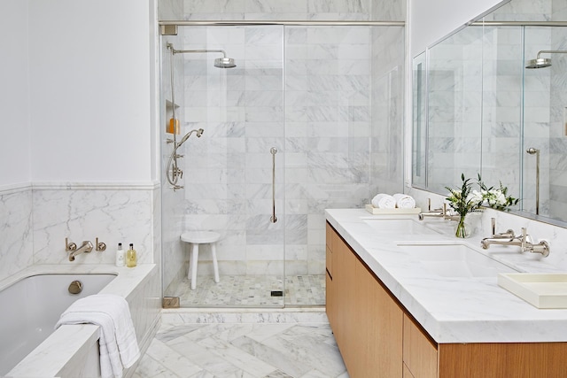 bathroom featuring double vanity, a garden tub, marble finish floor, a shower stall, and a sink