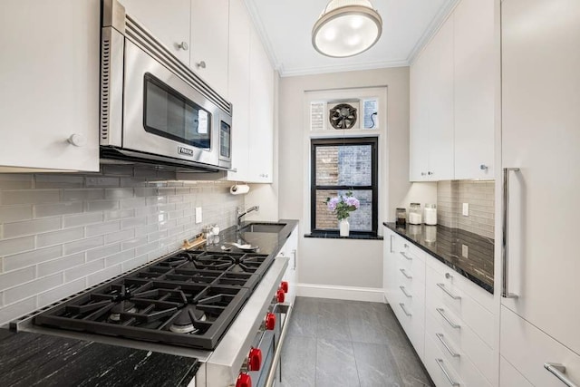 kitchen with ornamental molding, sink, white cabinets, and backsplash