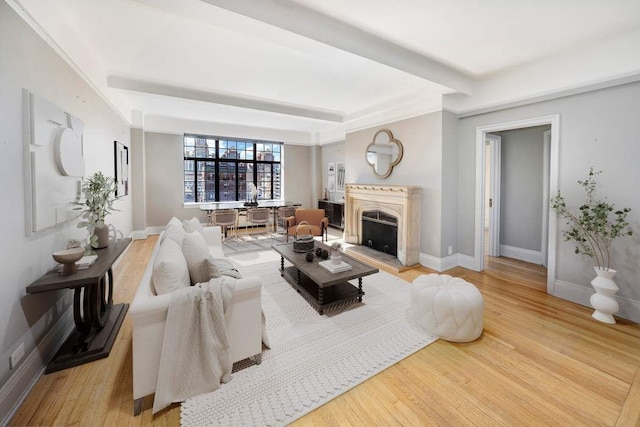 living room with beam ceiling and light hardwood / wood-style floors