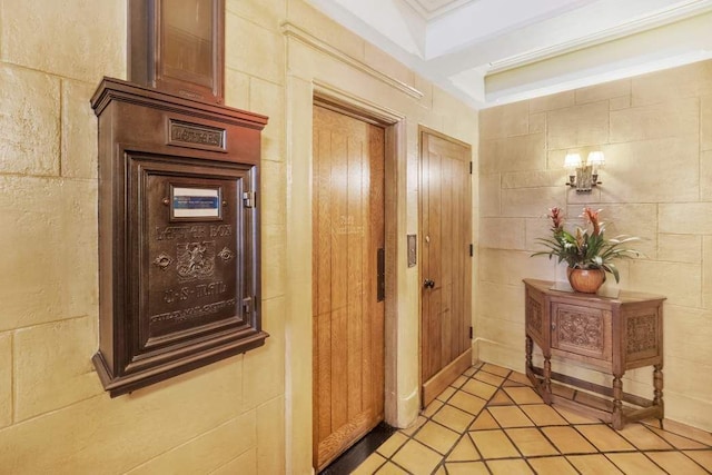 corridor with crown molding and tile walls