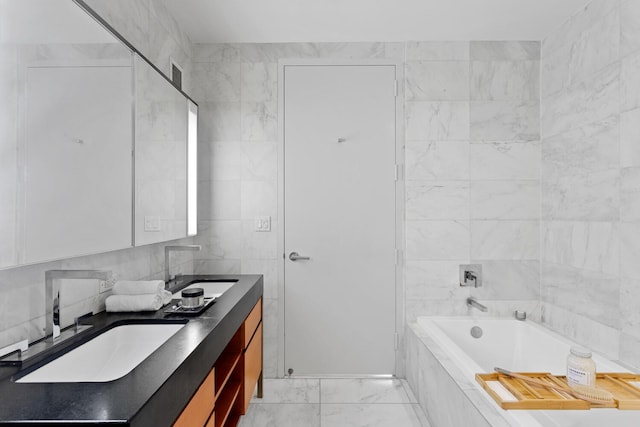 75 Wall St Unit 34M, New York City, NY 10005 - bathroom with double vanity, a bath, marble look tiles, and tile walls