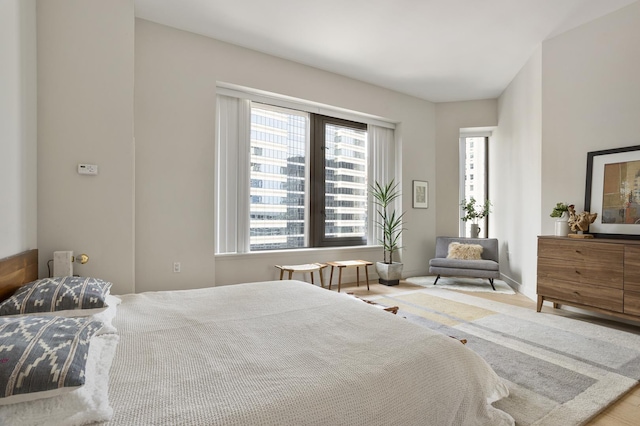 75 Wall St Unit 34M, New York City, NY 10005 - bedroom featuring multiple windows and wood finished floors